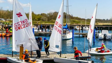 Sailing dinghies landing at a pier in the marina