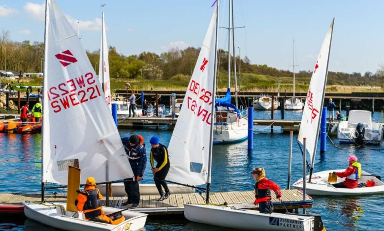 Sailing dinghies landing at a pier in the marina